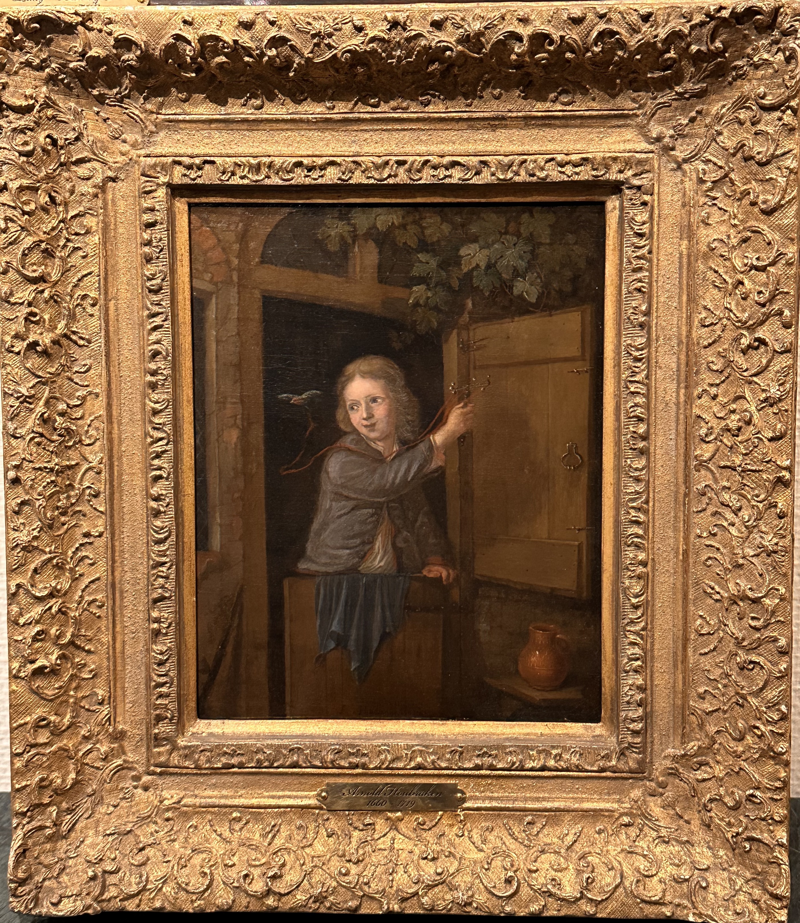 Arnold Houbraken 1660-1719 - A boy standing in a doorway holding  a finch on a string - Oil on canvas - Detail